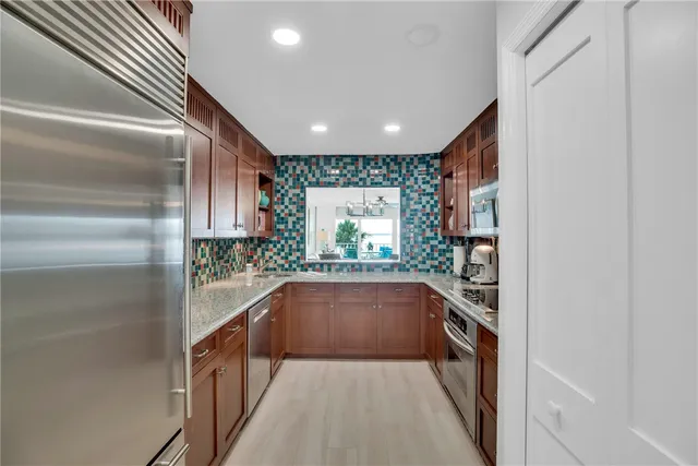 a hallway with an outdoor view of the kitchen