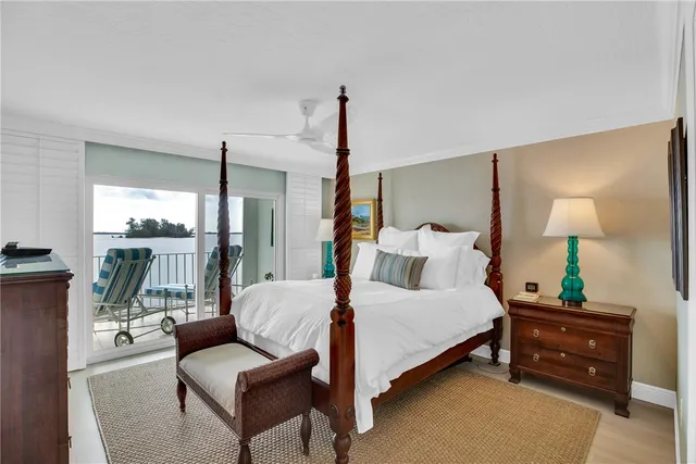 a bedroom with a bed and a lamp next to a window