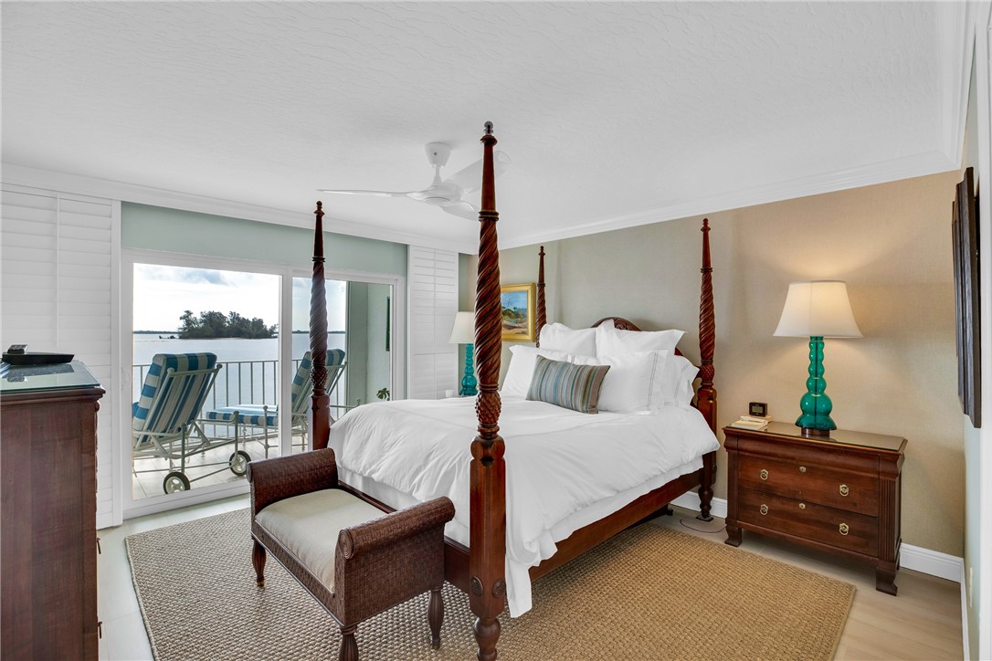 5914 South River Run Drive, Unit 5914 Sebastian, FL 32958 - Photo 19 of 36 a bedroom with a bed and a lamp next to a window