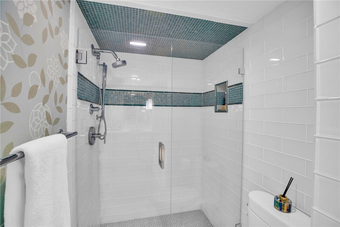 5914 South River Run Drive, Unit 5914 Sebastian, FL 32958 - Photo 23 of 36 a bathroom with a mirror and a shower