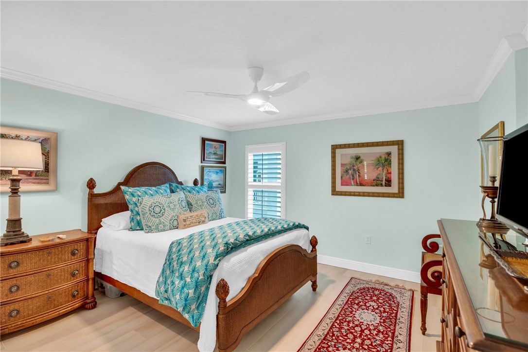 5914 South River Run Drive, Unit 5914 Sebastian, FL 32958 - Photo 26 of 36 a bedroom with a bed and a flat screen tv