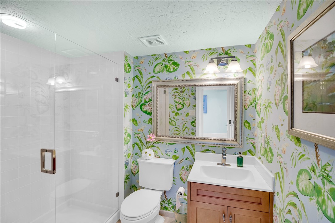 5914 South River Run Drive, Unit 5914 Sebastian, FL 32958 - Photo 28 of 36 a bathroom with a granite countertop sink and a mirror