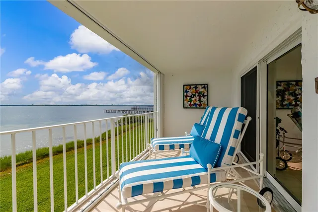 a view of a chairs and table in a balcony