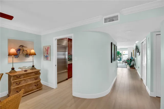 a view of a hallway with closet and wooden floor