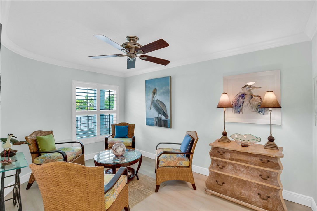 5914 South River Run Drive, Unit 5914 Sebastian, FL 32958 - Photo 9 of 36 a living room with furniture and a chandelier