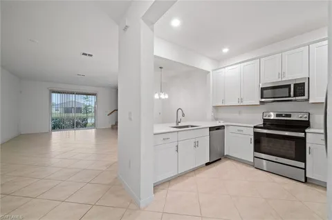 a kitchen with a sink and a stove top oven