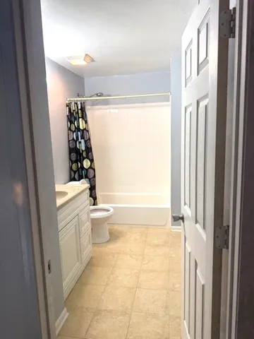 a bathroom with a toilet a sink and a shower