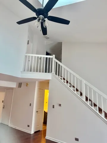 a view of a hallway with entryway a wooden floor and front door
