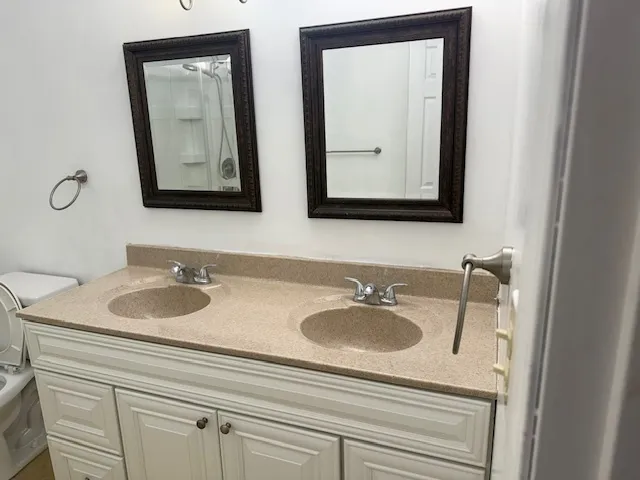 a bathroom with 2 sink and a mirror