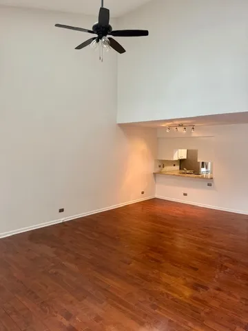 a view of a room with wooden floor