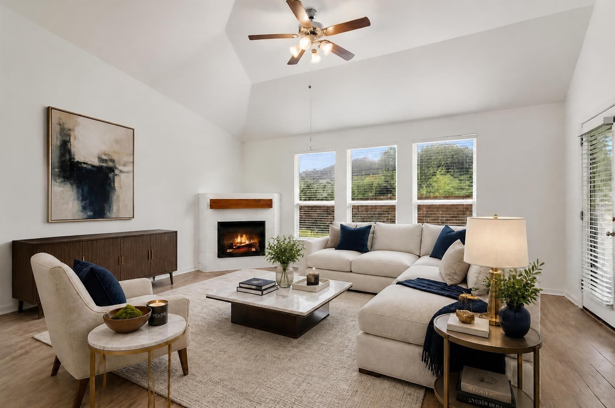 903 Willowick Road Houston, TX 77090 - Photo 2 of 47 The living room opens into a spacious central gathering area with high ceilings, a gaslog fireplace, and a clean connection to the kitchen. The room feels bright, open, and designed as the heart of the home. Virtually staged.