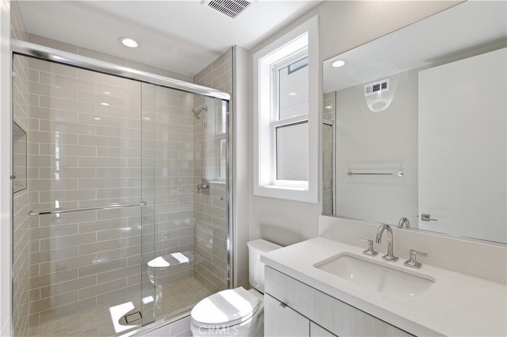 156 Apron Irvine, CA 92618 - Photo 26 of 40 a bathroom with a sink a toilet and shower