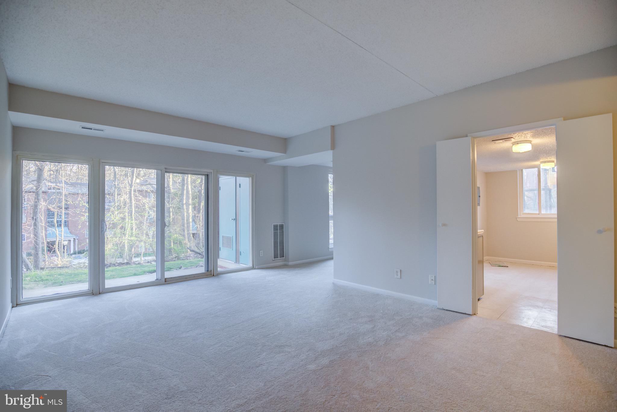 11813 Breton Court, Unit 2B Reston, VA 20191 - Photo 2 of 17 a view of an empty room with a window