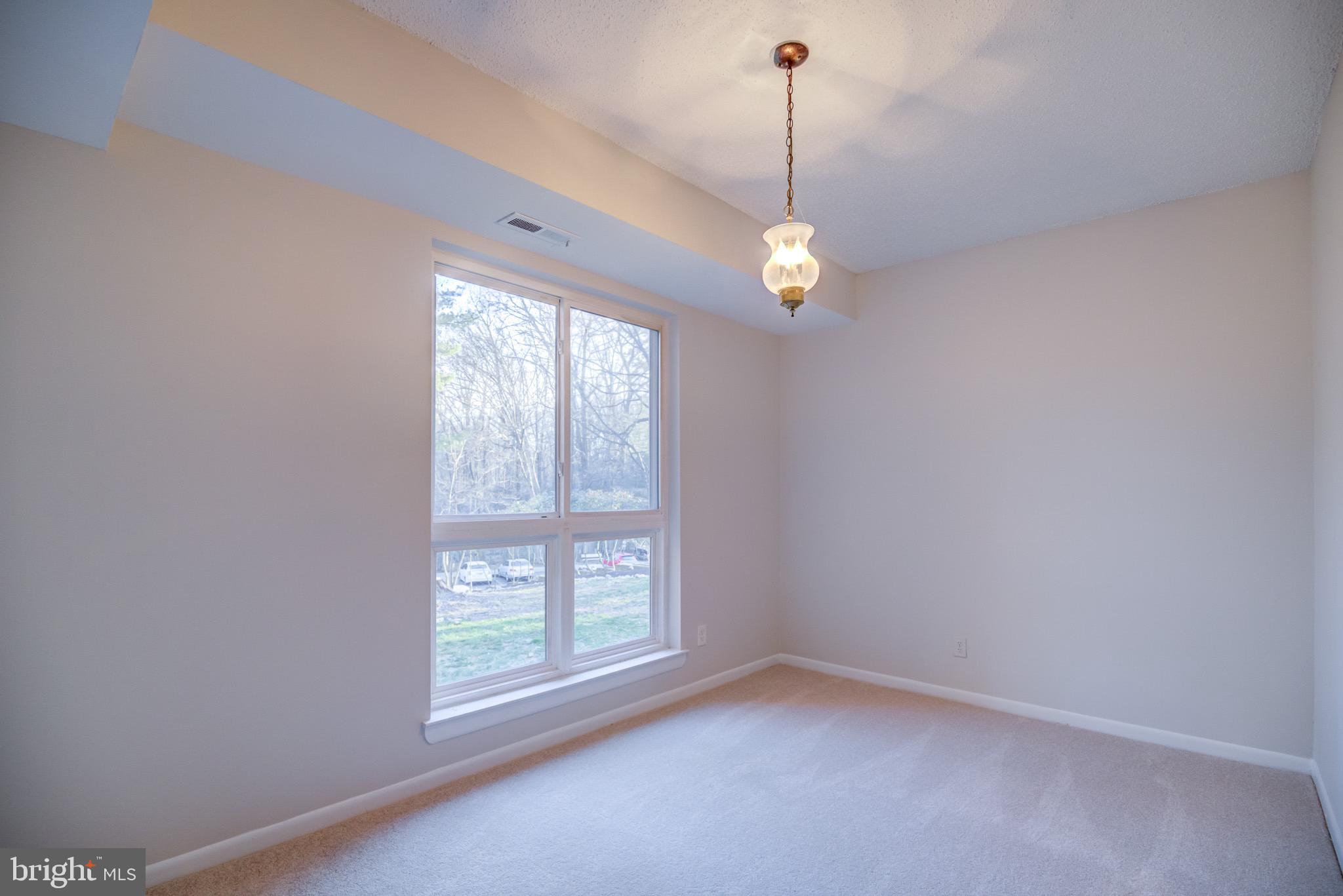 11813 Breton Court, Unit 2B Reston, VA 20191 - Photo 4 of 17 a view of an empty room with a window