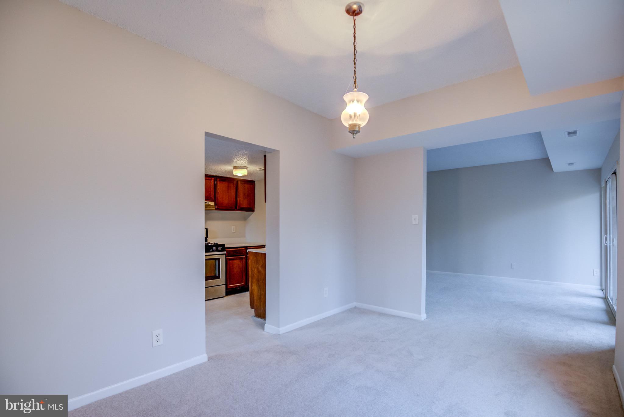 11813 Breton Court, Unit 2B Reston, VA 20191 - Photo 5 of 17 a view of empty room with a ceiling fan and window