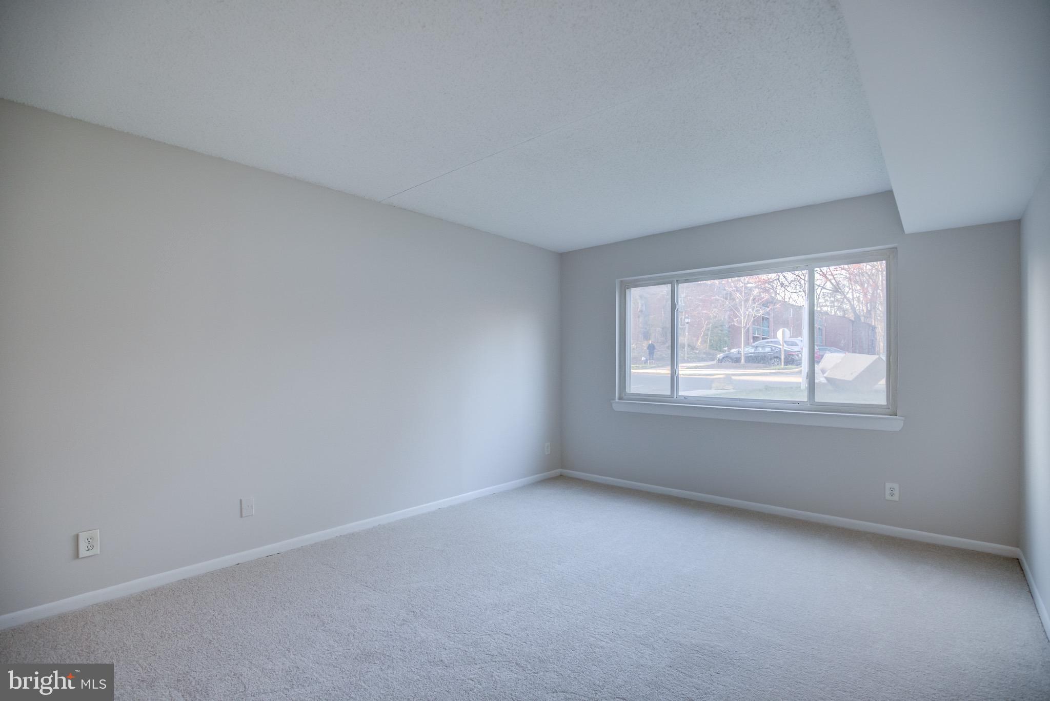 11813 Breton Court, Unit 2B Reston, VA 20191 - Photo 8 of 17 an empty room with windows