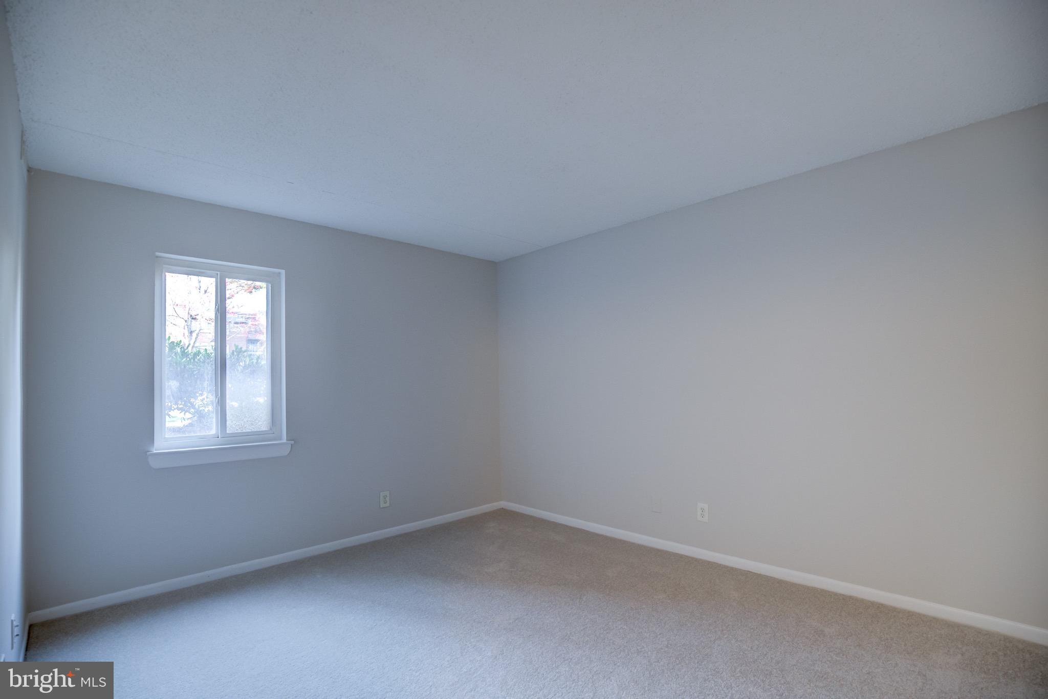 11813 Breton Court, Unit 2B Reston, VA 20191 - Photo 9 of 17 an empty room with a window