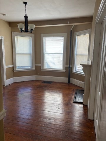 52 Harvest Street, Unit 1 Boston, MA 02125 - Photo 11 of 35 an empty room with wooden floor and windows