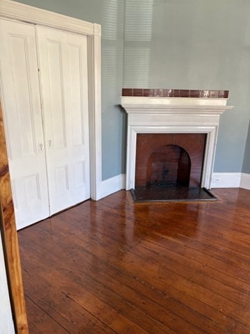 52 Harvest Street, Unit 1 Boston, MA 02125 - Photo 16 of 35 a view of a livingroom with wooden floor and a fireplace