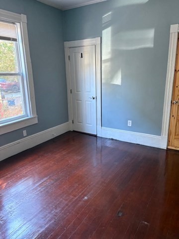 52 Harvest Street, Unit 1 Boston, MA 02125 - Photo 17 of 35 an empty room with wooden floor and windows