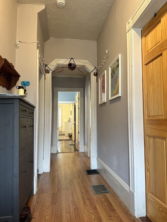 52 Harvest Street, Unit 1 Boston, MA 02125 - Photo 21 of 35 a view of a hallway with wooden floor and windows