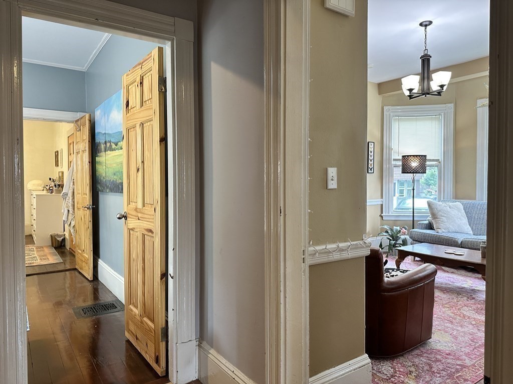 52 Harvest Street, Unit 1 Boston, MA 02125 - Photo 22 of 35 a living room with furniture and a chandelier
