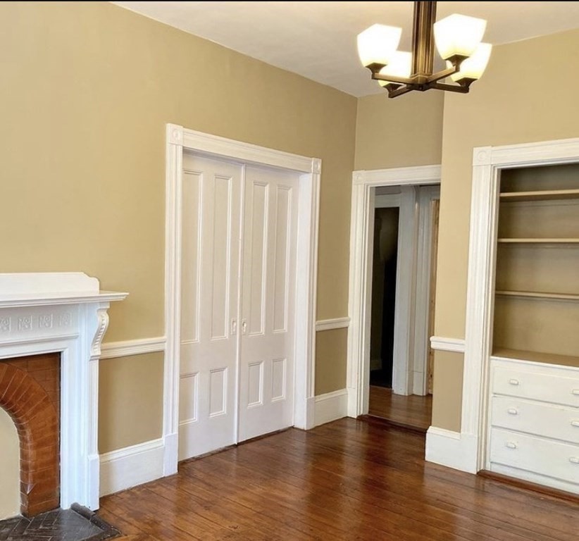52 Harvest Street, Unit 1 Boston, MA 02125 - Photo 23 of 35 a view of empty room with wooden floor