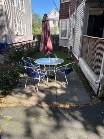 52 Harvest Street, Unit 1 Boston, MA 02125 - Photo 24 of 35 a view of a backyard with furniture and a table