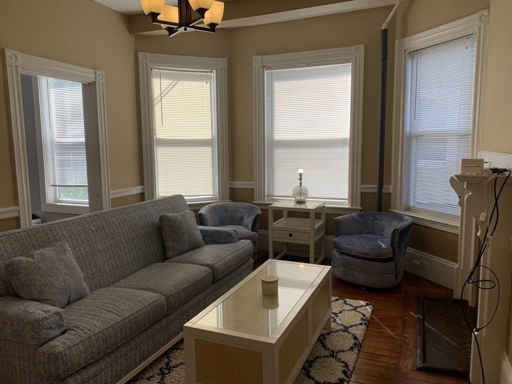 52 Harvest Street, Unit 1 Boston, MA 02125 - Photo 32 of 35 a living room with furniture and a window