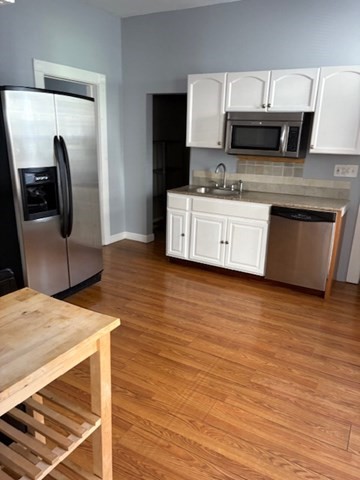 52 Harvest Street, Unit 1 Boston, MA 02125 - Photo 35 of 35 a kitchen with stainless steel appliances a microwave a stove and refrigerator