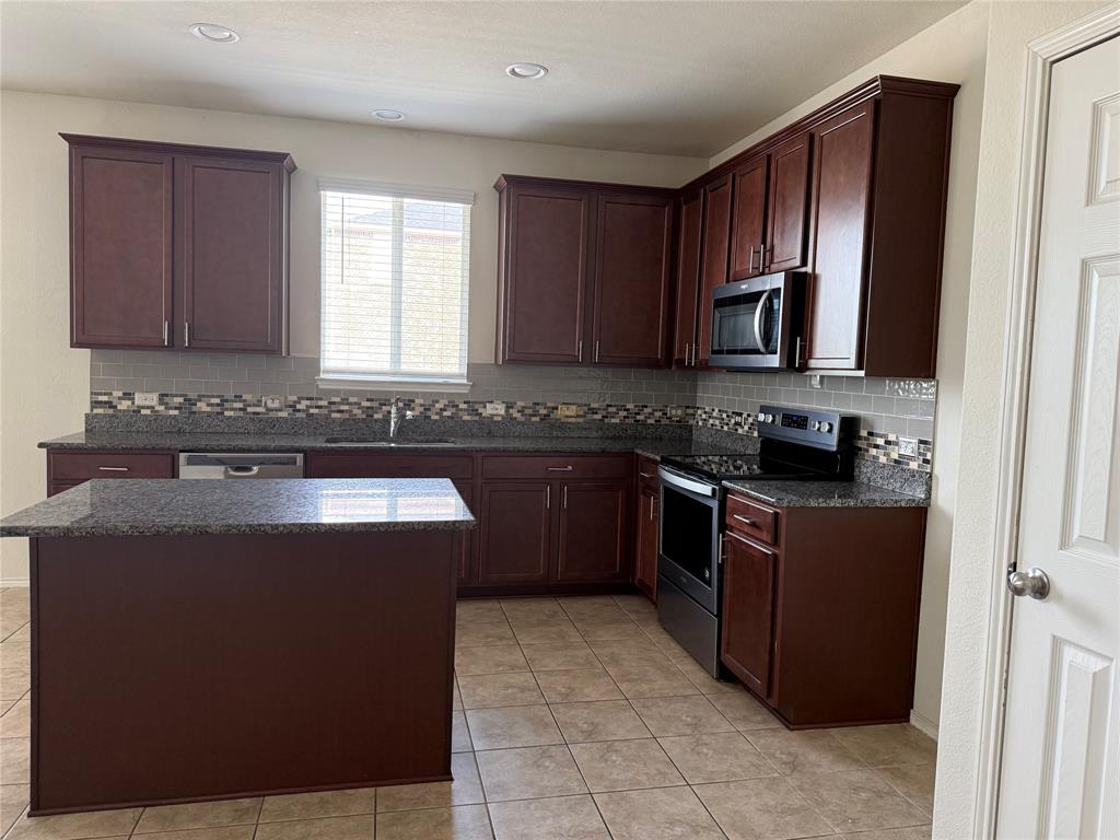 2225 Heaton Street Forney, TX 75126 - Photo 6 of 21 Granite countertops and stainless appliances.