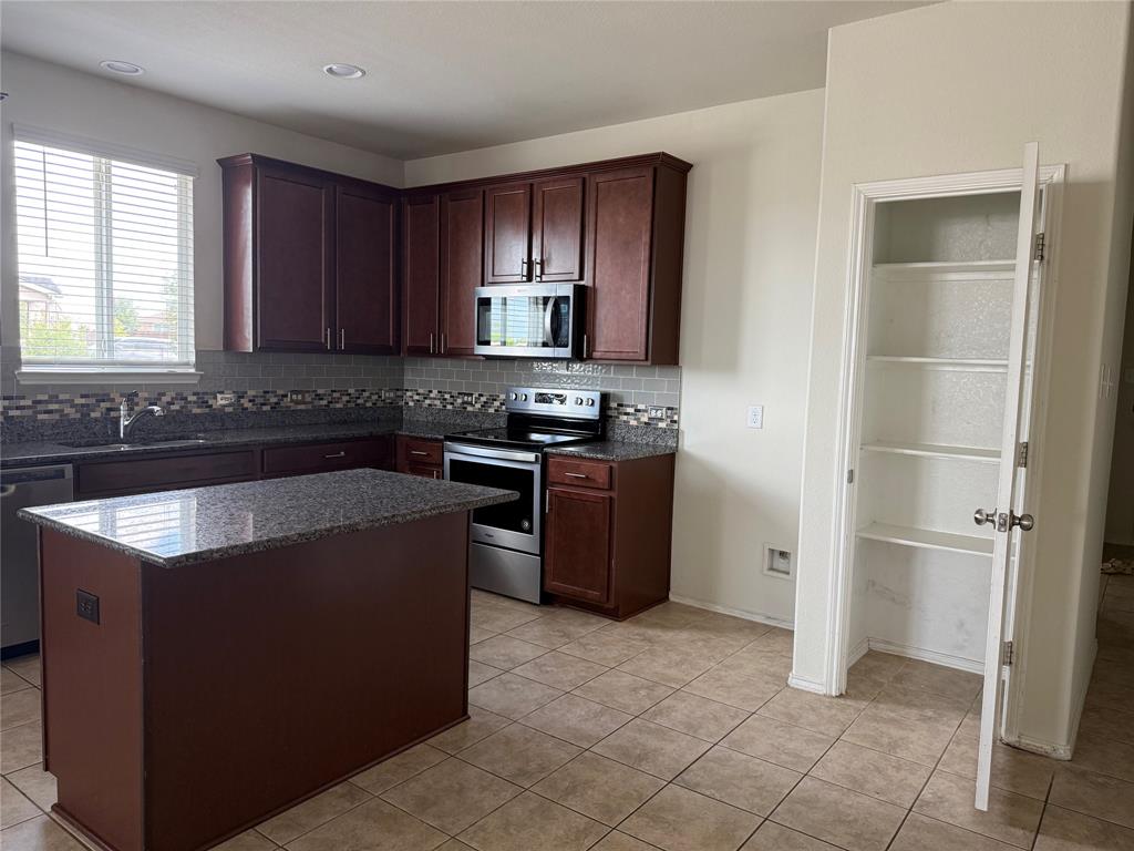 2225 Heaton Street Forney, TX 75126 - Photo 7 of 21 Another view of kitchen with pantry door open.