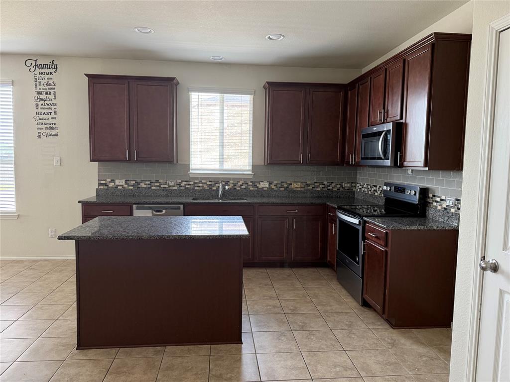 2225 Heaton Street Forney, TX 75126 - Photo 8 of 21 Another view of kitchen showing eat-in area to the left.