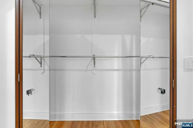 a view of a room with wooden floor