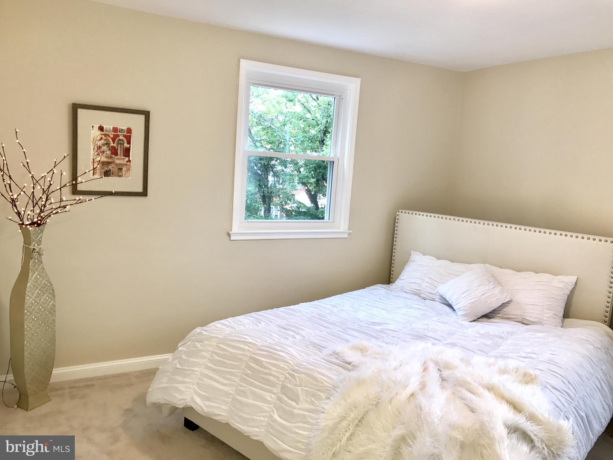 1713 Heathfield Road Baltimore, MD 21239 - Photo 13 of 26 a bedroom with a bed and a window