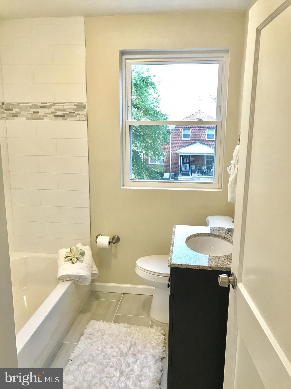 1713 Heathfield Road Baltimore, MD 21239 - Photo 14 of 26 a bathroom with a sink a toilet and tub