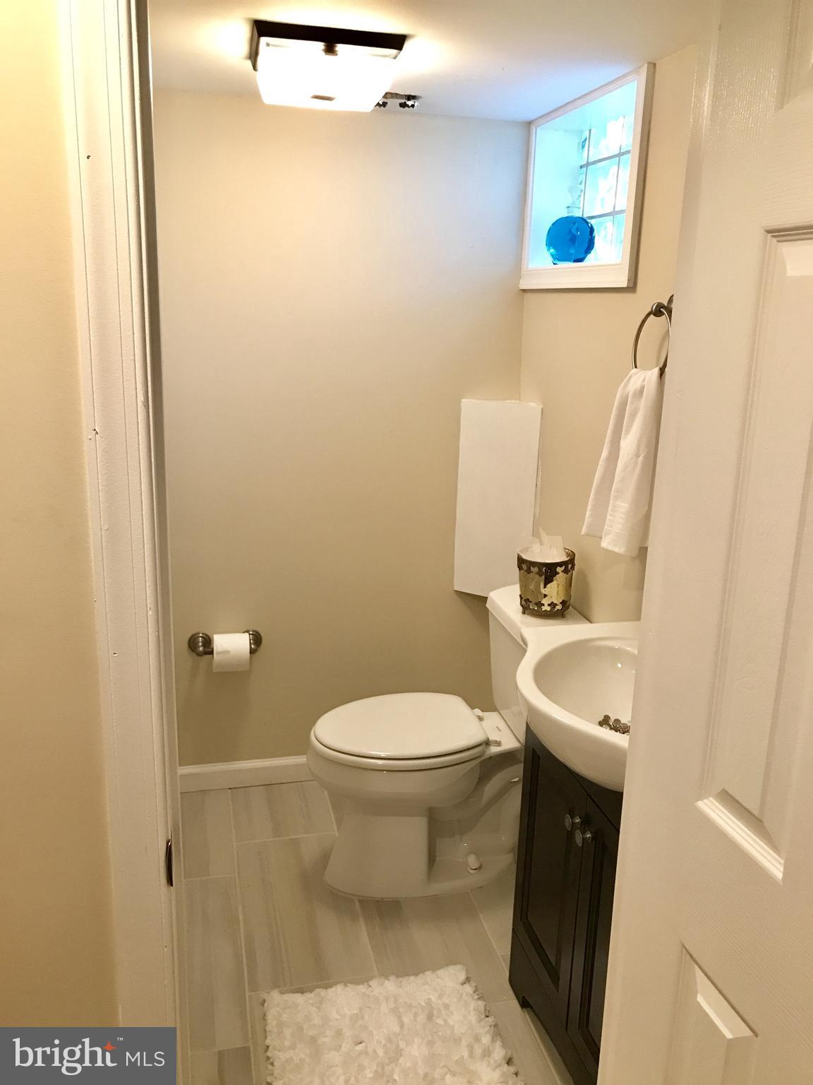 1713 Heathfield Road Baltimore, MD 21239 - Photo 21 of 26 a bathroom with a sink and a toilet