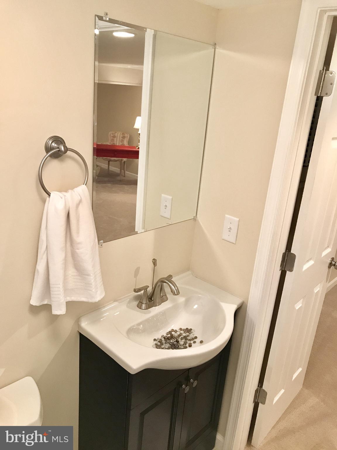 1713 Heathfield Road Baltimore, MD 21239 - Photo 24 of 26 a bathroom with a sink and a mirror