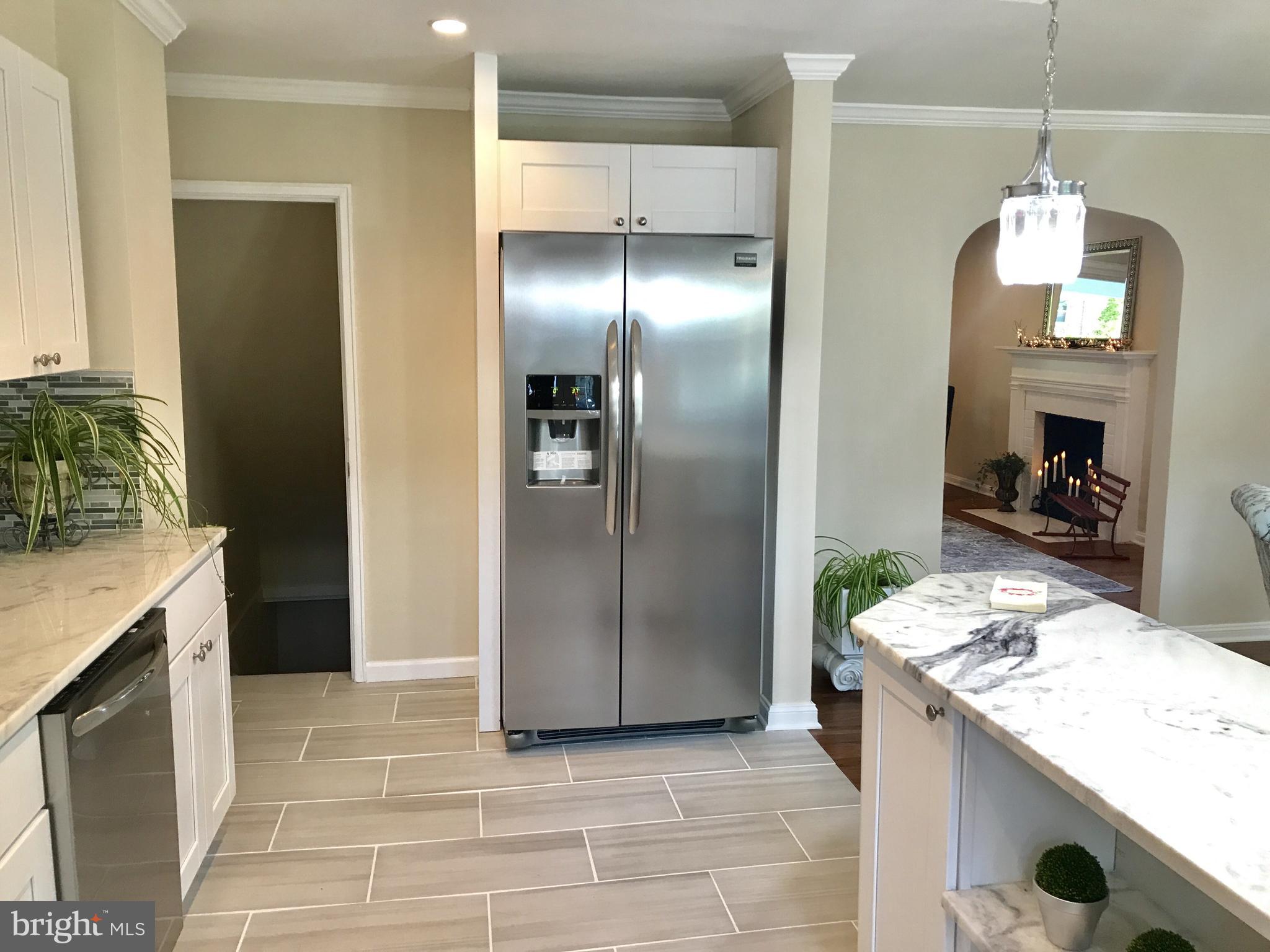 1713 Heathfield Road Baltimore, MD 21239 - Photo 7 of 26 a kitchen with granite countertop a refrigerator a stove and a sink