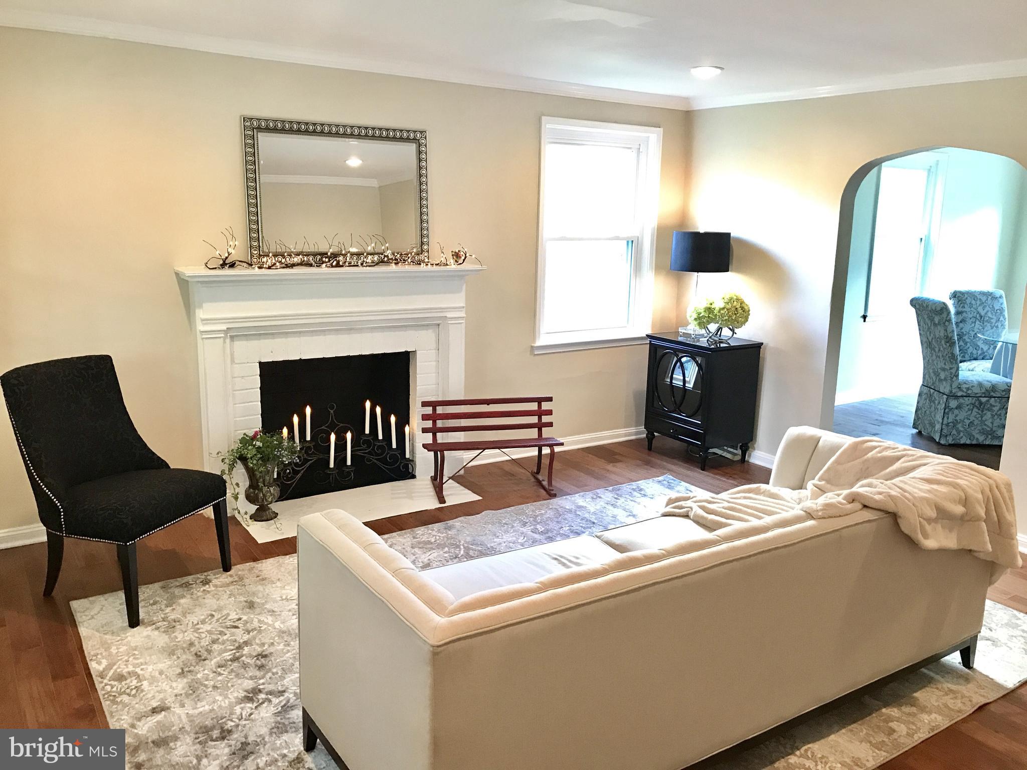 1713 Heathfield Road Baltimore, MD 21239 - Photo 9 of 26 a living room with furniture and a fireplace