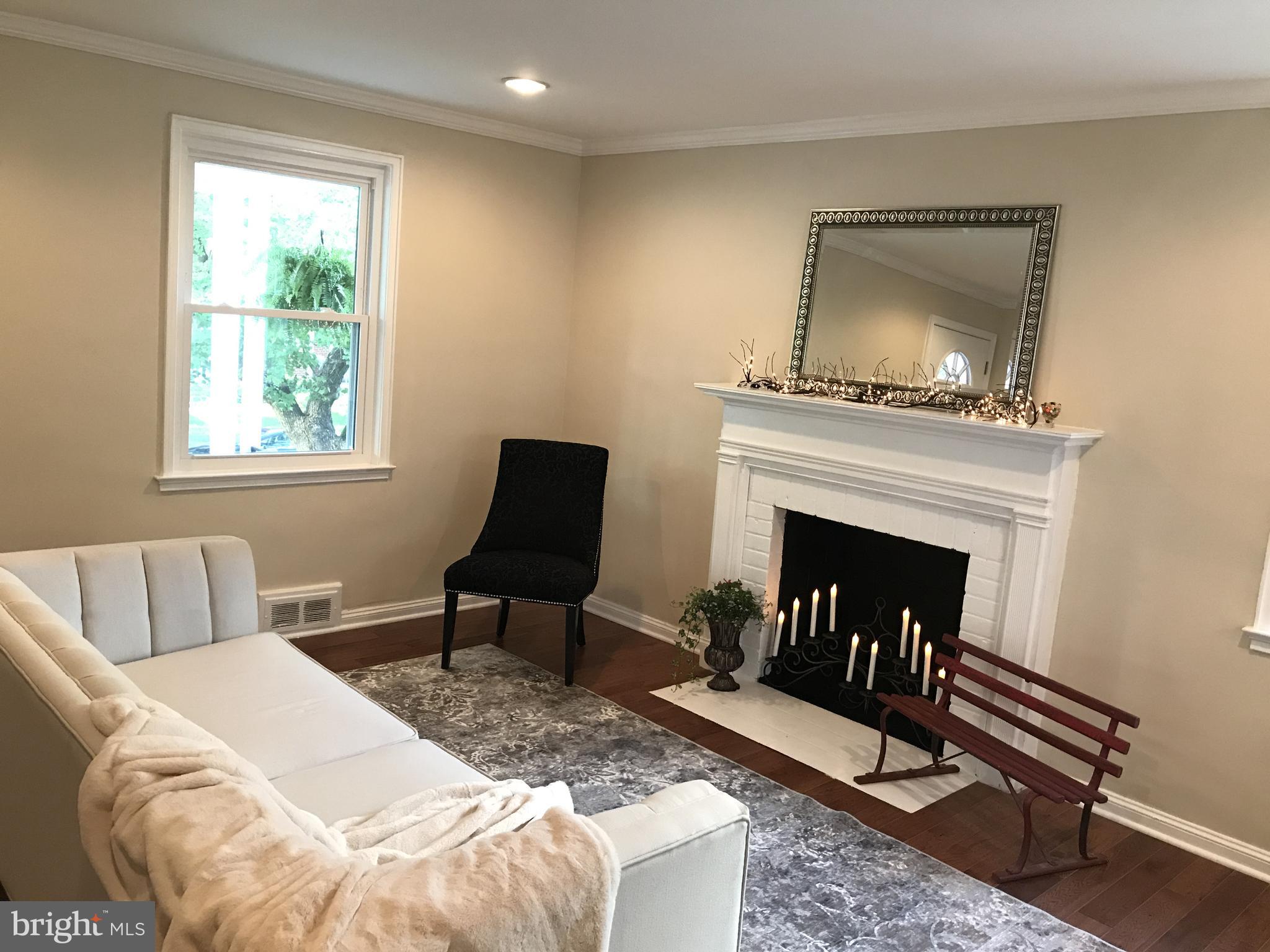 1713 Heathfield Road Baltimore, MD 21239 - Photo 10 of 26 a living room with furniture and a fireplace
