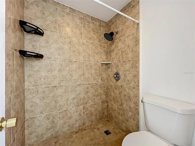 a view of an empty room with a floor to ceiling window next to a yard