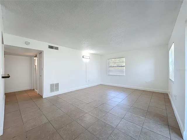 a view of an empty room and a window