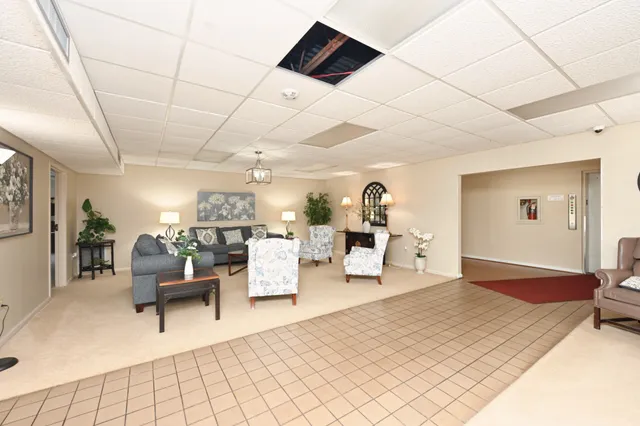 an aerial view of a city with lots of residential buildings lake and mountain view in back