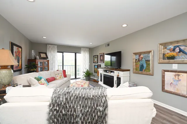 a bed room with a bed a television and a large window