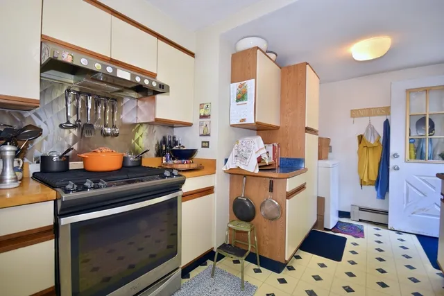 a kitchen with stainless steel appliances a stove a sink and a cabinets