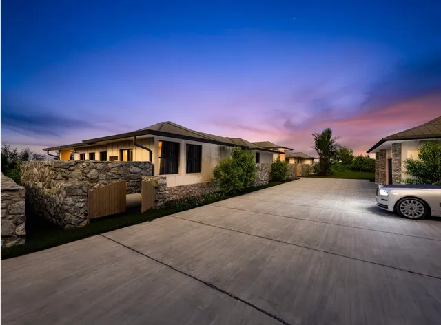 a front view of a house with swimming pool having outdoor seating