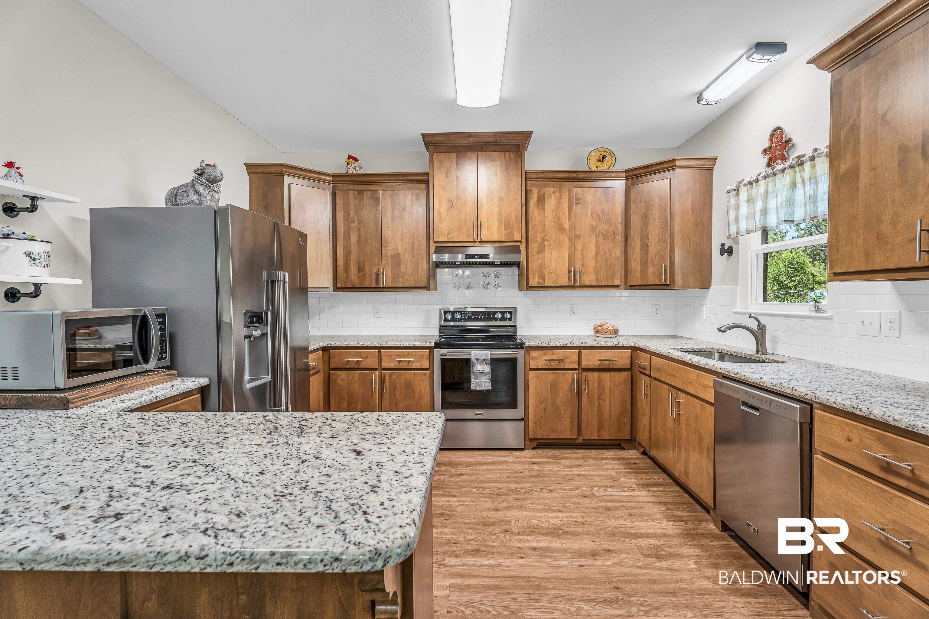 18255 Cactus Court Elberta, AL 36530 - Photo 20 of 53 Kitchen featuring wood finish cabinetry, stainless steel appliances, and light stone countertops