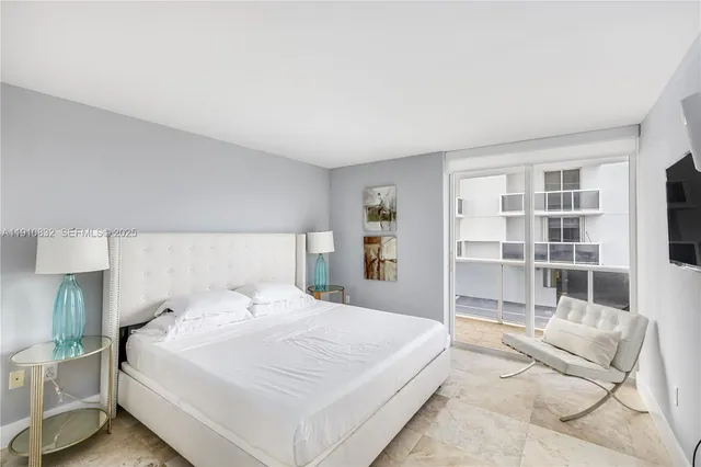 a spacious bedroom with a bed and a large window