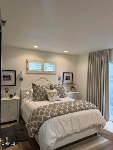 a bedroom with a large bed and a window